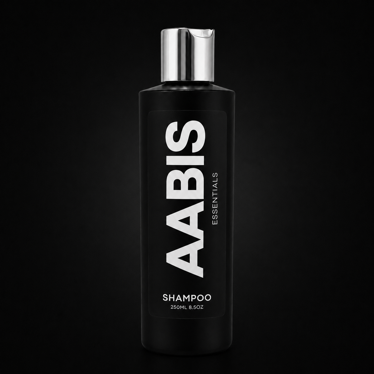 A 250ml black bottle of AABIS Essentials Shampoo with a reflective silver cap, set against a solid black background.